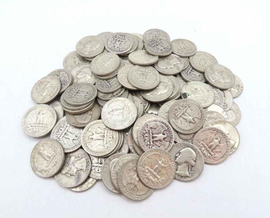 Pile of silver American coins, including quarters and dimes, on a white background.