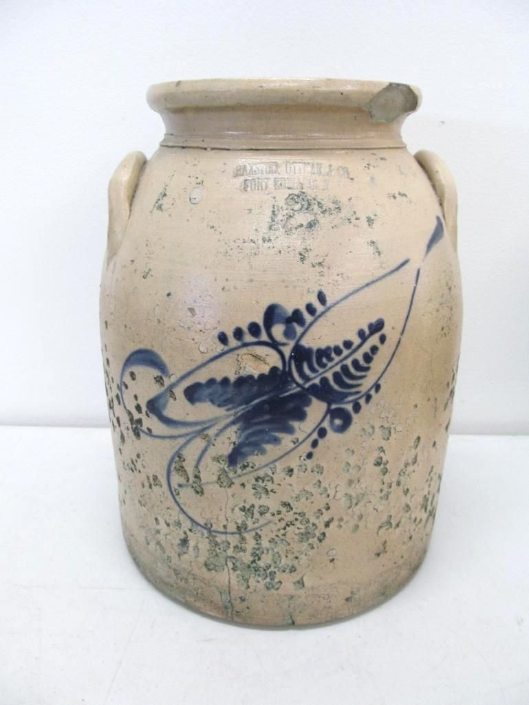 Tan stoneware crock with blue floral decoration, side handles.