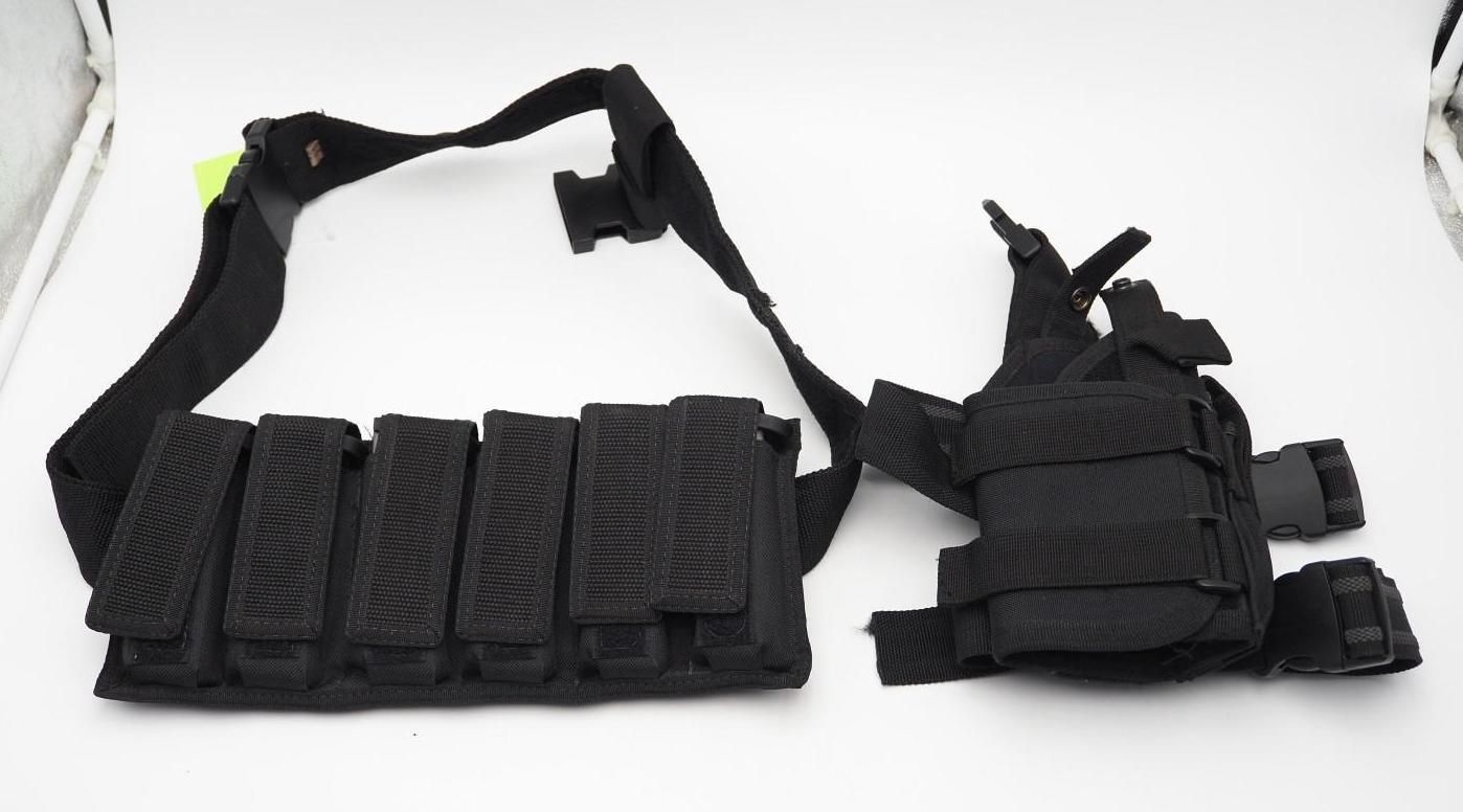 Black tactical belt with pouches and holster laid out on a white background