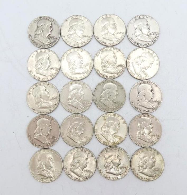 Twenty silver Franklin half dollars, heads facing left, arranged in a grid on a white surface.