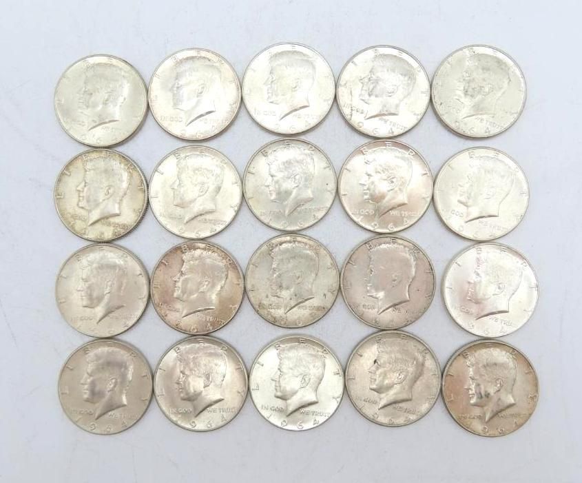 Twenty silver Kennedy half-dollar coins arranged in a grid on a white surface.
