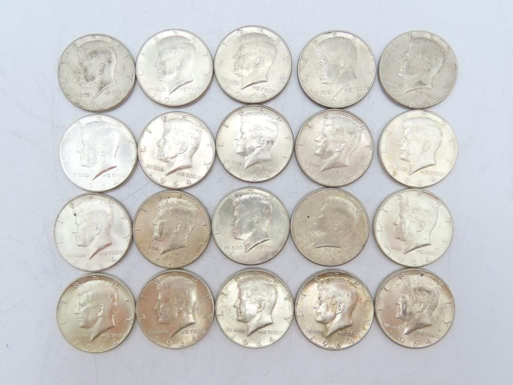 Twenty silver Kennedy half-dollar coins arranged in a square on a white surface.
