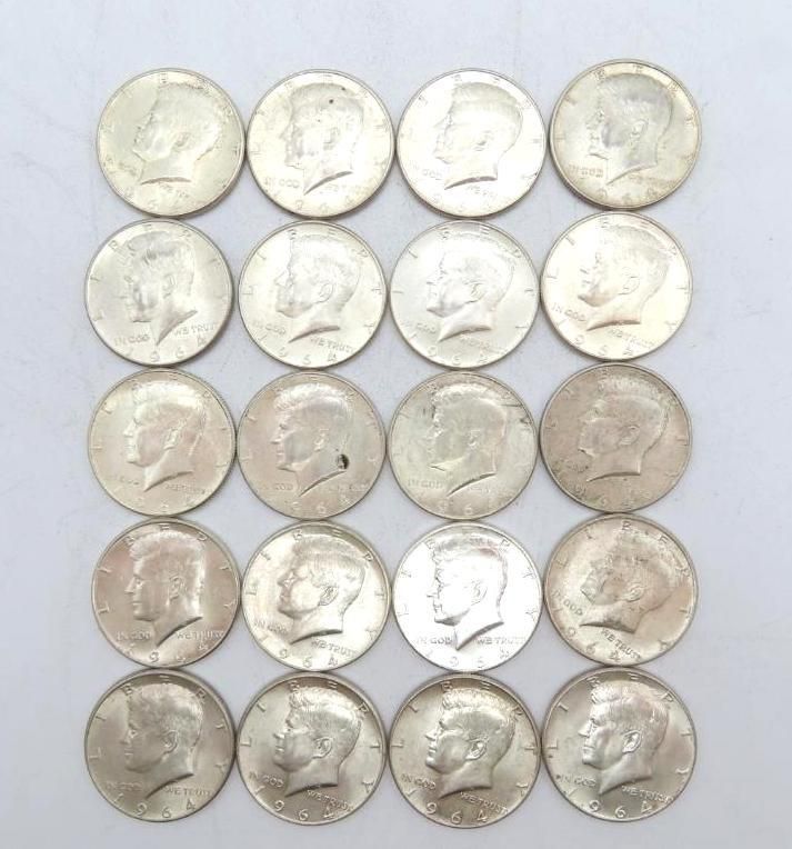 Twenty Kennedy half dollars, heads facing up. Silver coins on a white background.