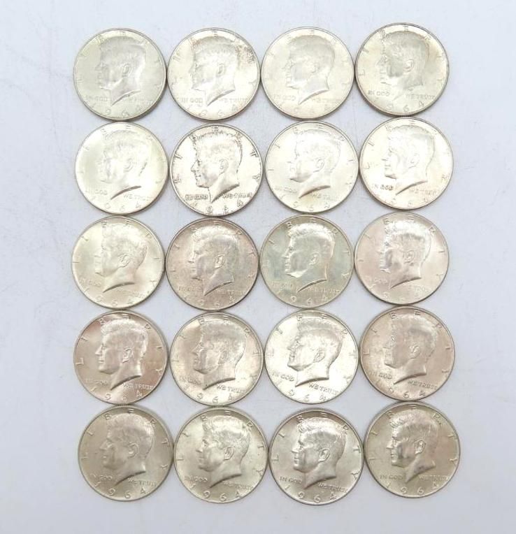 Twenty silver Kennedy half dollar coins, heads facing up, arranged in a grid.