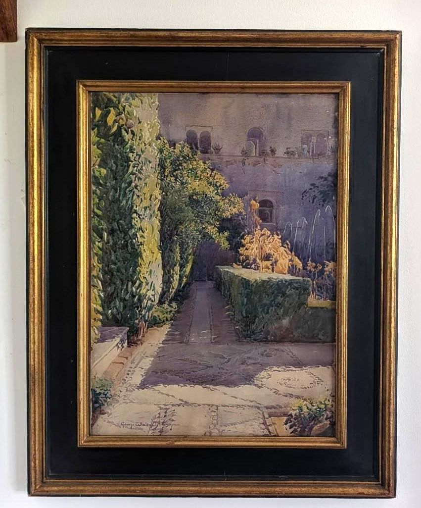 Framed painting of a sunlit garden path with hedges and trees beside a building.