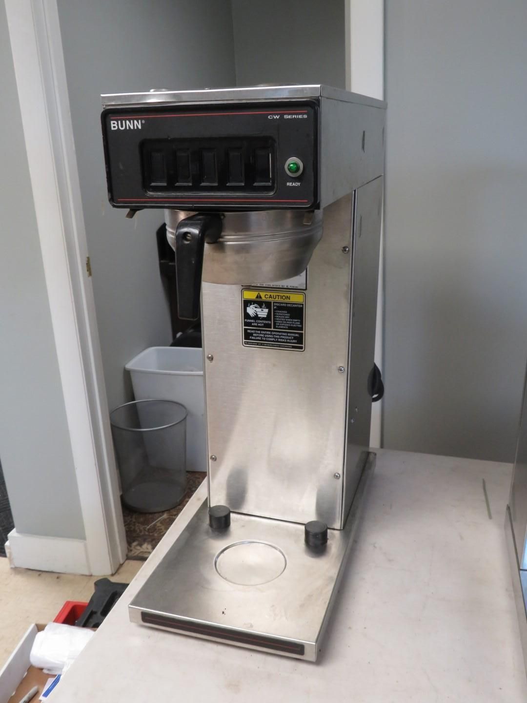 Commercial coffee maker, stainless steel, with multiple brew heads.