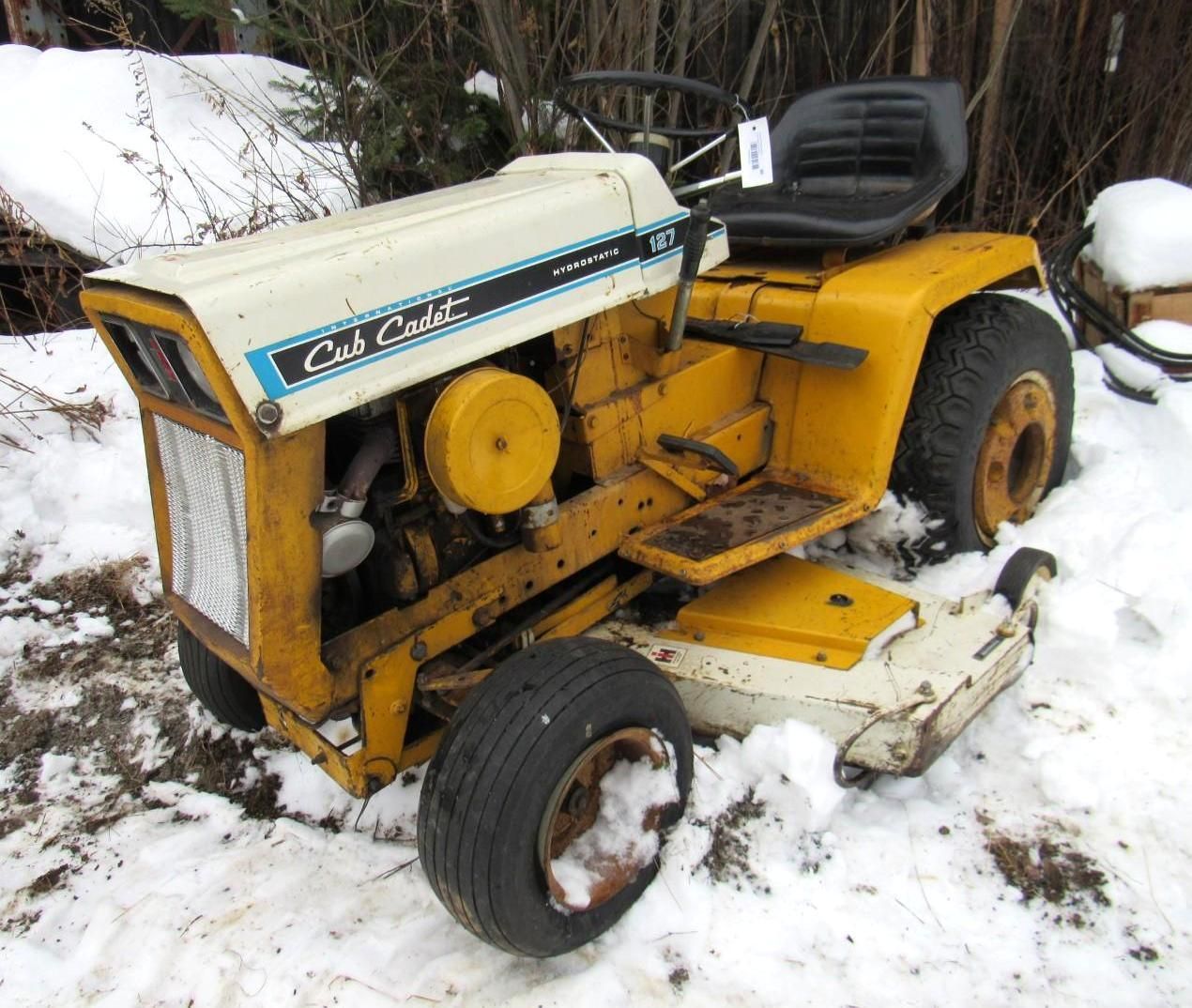Yellow Cub Cadet lawn tractor in the snow.