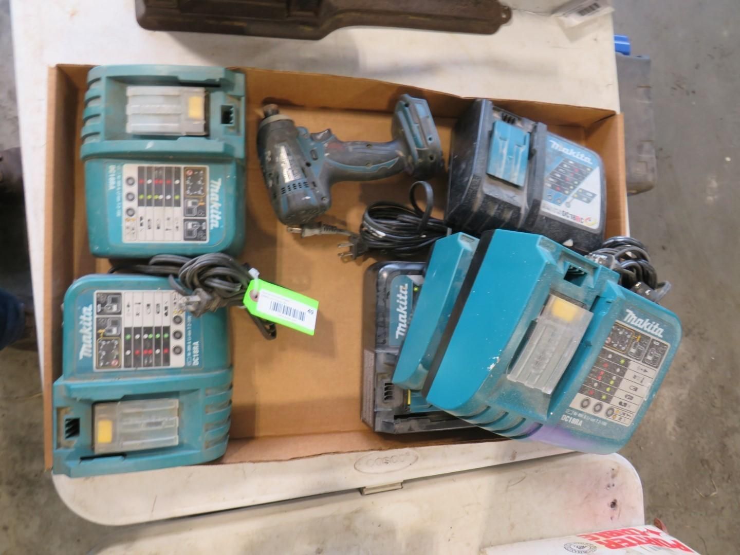 A box with Makita power tools: two chargers, a drill, and two batteries.