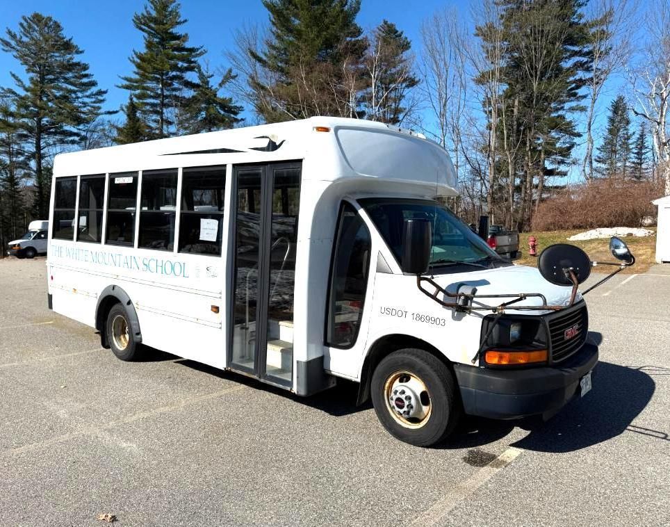 White school bus parked on asphalt