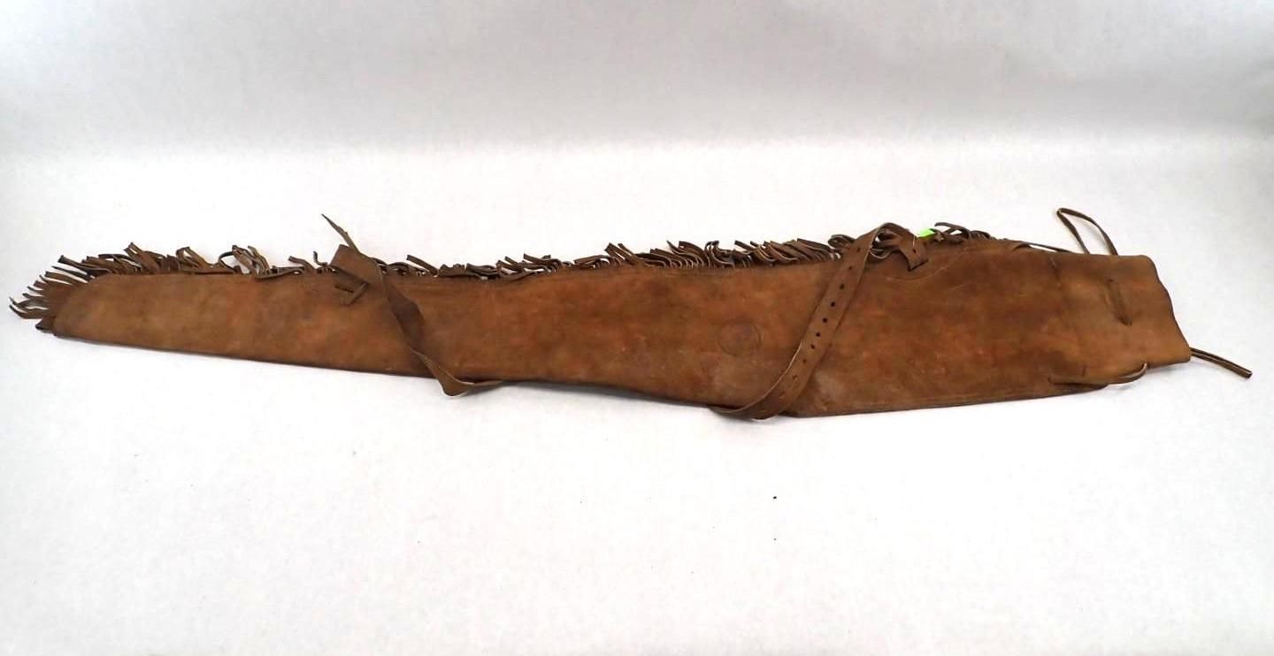 Brown leather quiver with fringe, on a white surface.