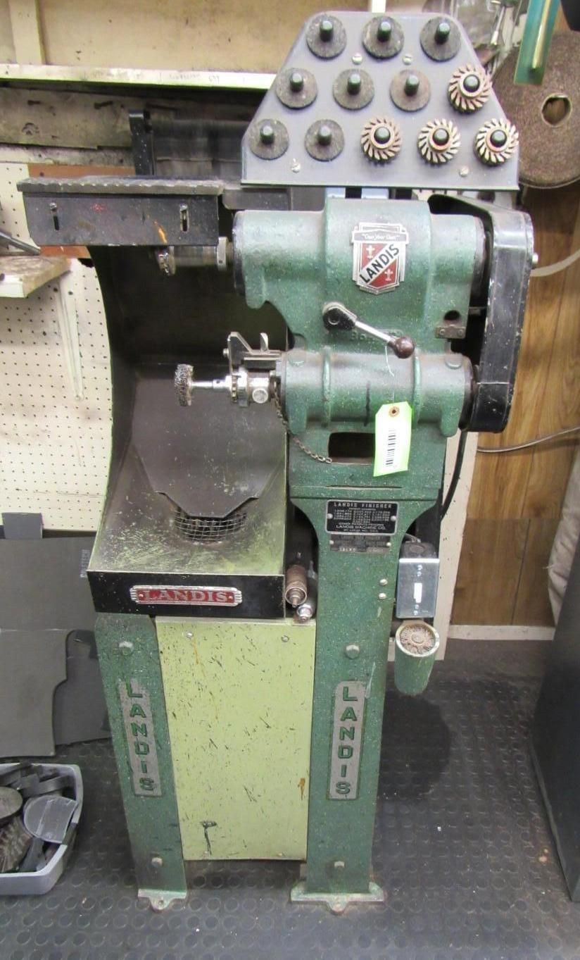 Green and gray Landis shoe repair machine with various tools and attachments.