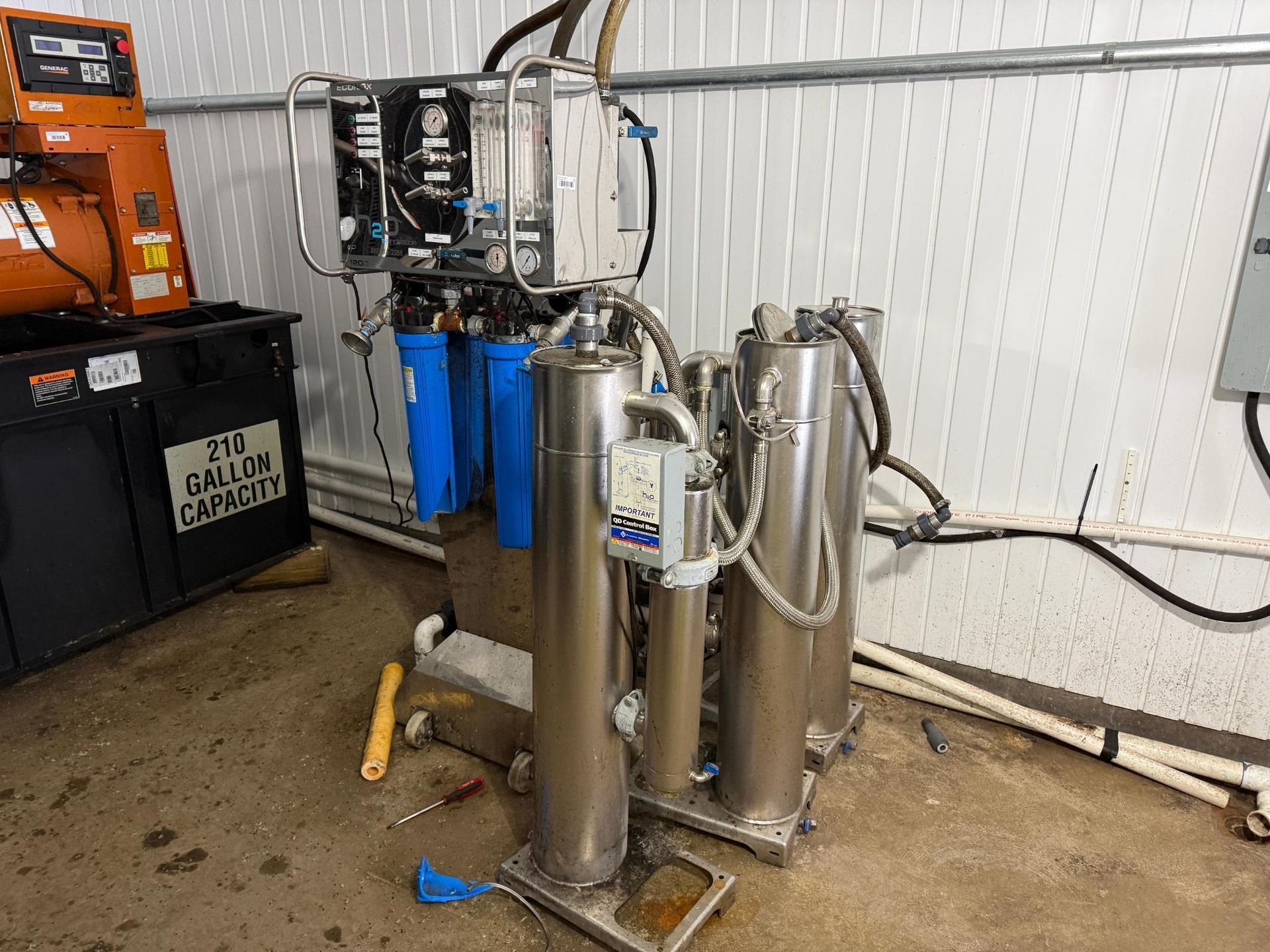 Water filtration system with blue and silver components, in an industrial setting.