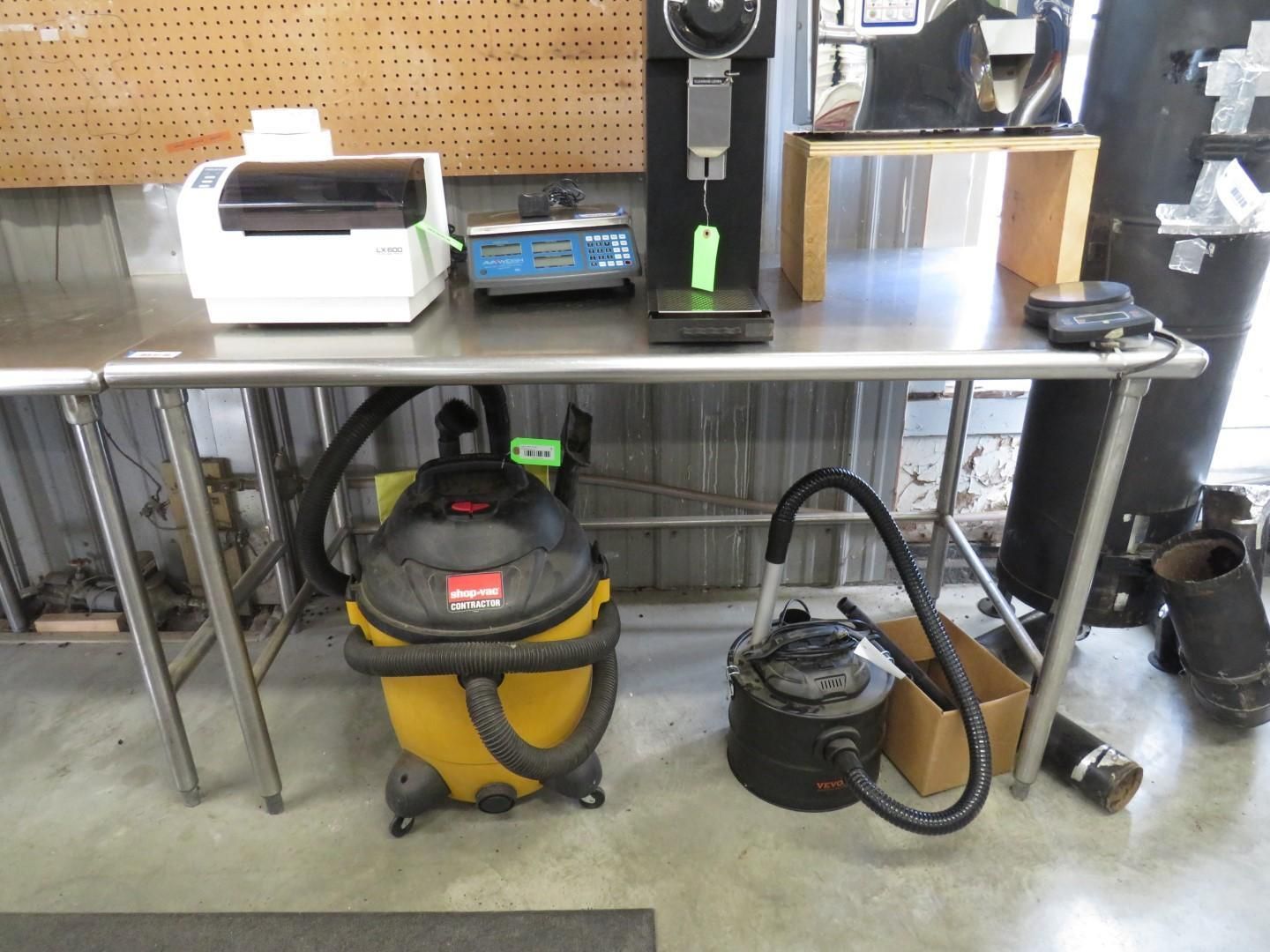 Stainless steel work table with equipment: printer, scale, tension meter, two vacuums.