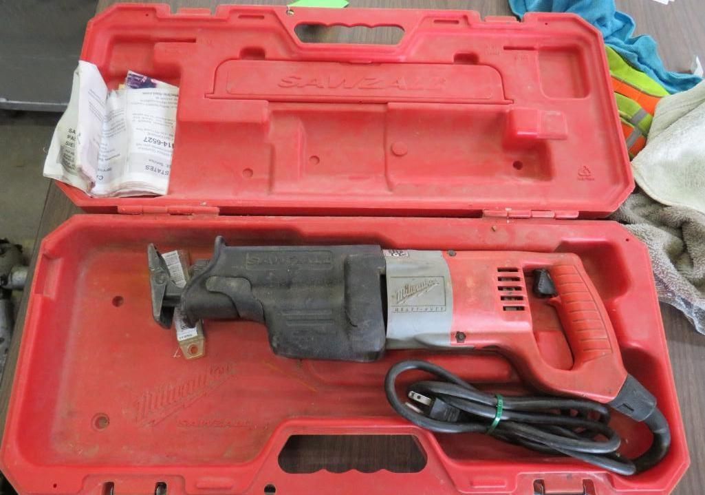 Red reciprocating saw in its red carrying case.