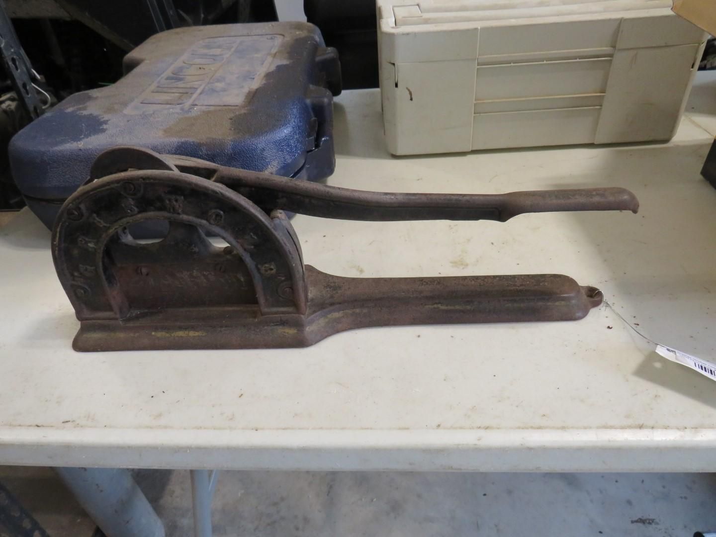 Antique cast-iron nutcracker on a white table.