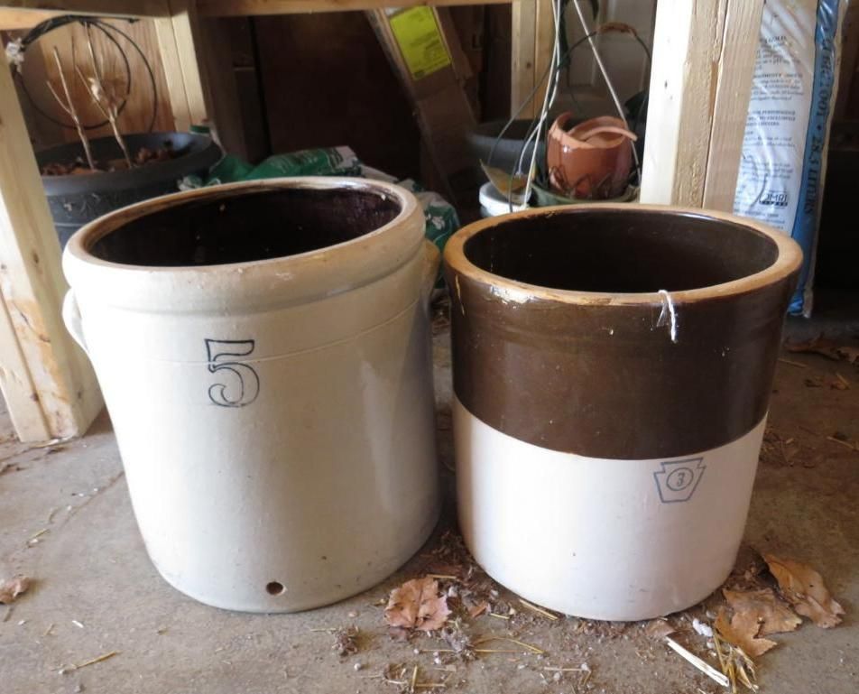 Two stoneware crocks, one white with a 5, the other brown and white.
