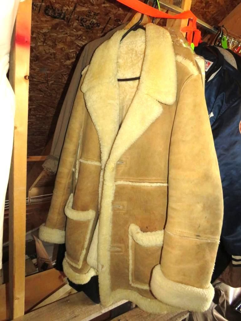 Tan shearling coat hanging on a rack.