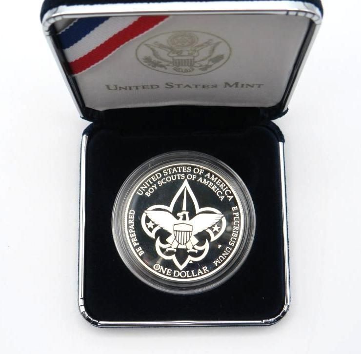 Silver Boy Scouts of America one dollar coin in display case.