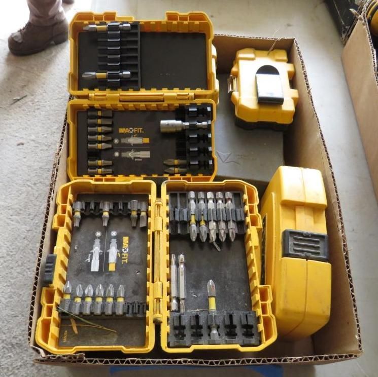 Yellow toolboxes and accessories inside a cardboard box.