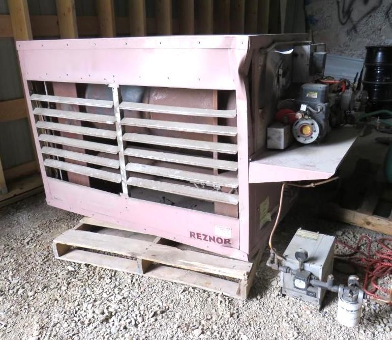 Pink Reznor industrial heater on a wooden pallet in a garage.