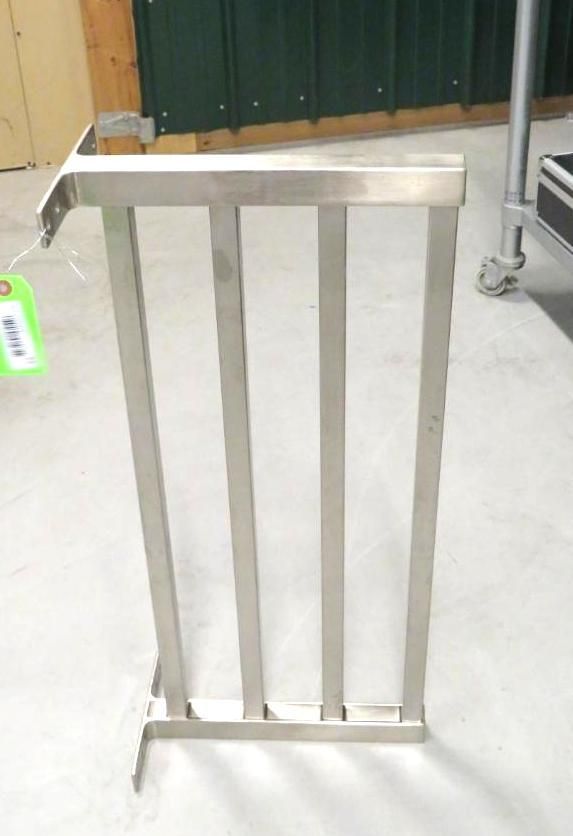 Stainless steel rack with four vertical bars; likely for food service use.