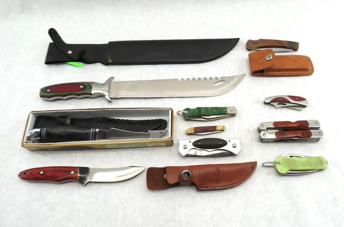 Collection of various knives and multi-tools on a white surface.