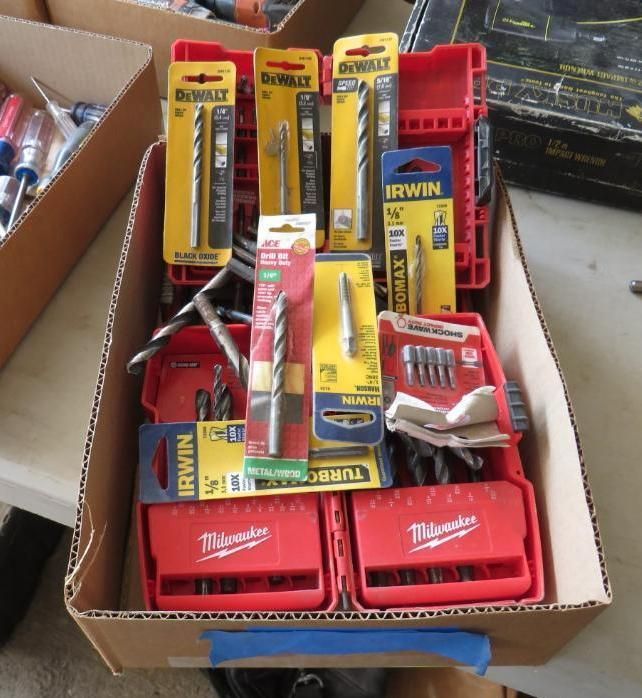 Box filled with drill bits from DeWalt, Irwin, Milwaukee, and other brands.