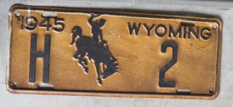 1945 Wyoming license plate with a bucking horse and rider; gold and black.