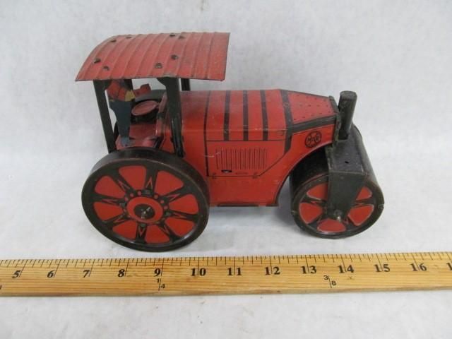 Red and black vintage toy steamroller with driver.