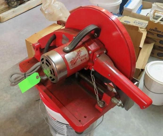 Red Milwaukee chop saw on a red base, ready to cut.