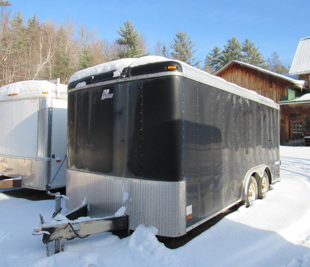 Black enclosed trailer in snow.