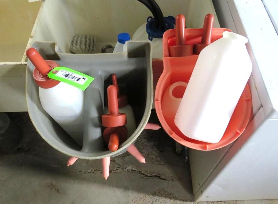 Two calf feeding stations with bottles and teats.