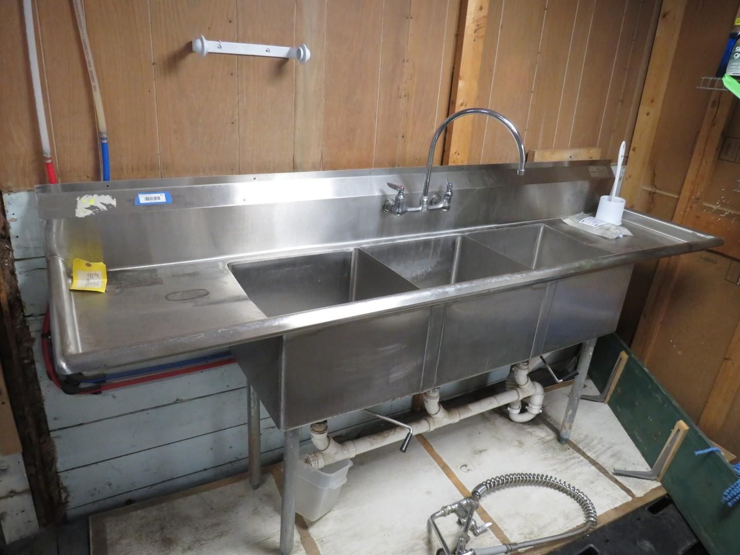 Stainless steel triple sink.