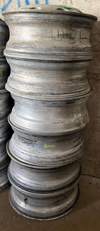 Stack of silver-colored metal wheels. The wheels have a tiered design and are stacked vertically.