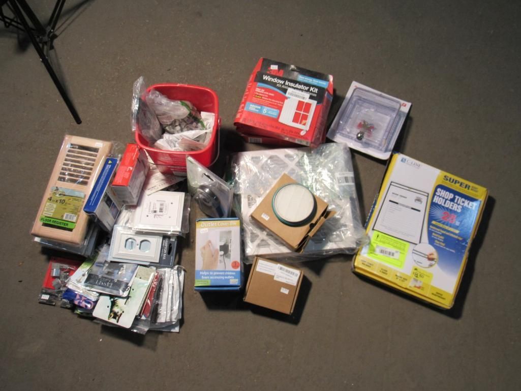 Pile of various boxes and containers on a dark surface, including red, yellow, and white packaging.
