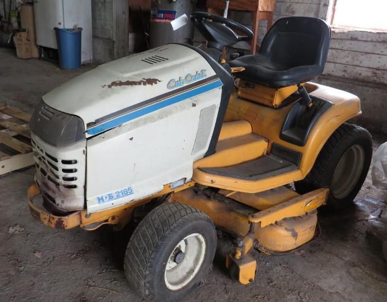 Yellow and white Cub Cadet riding lawn mower.