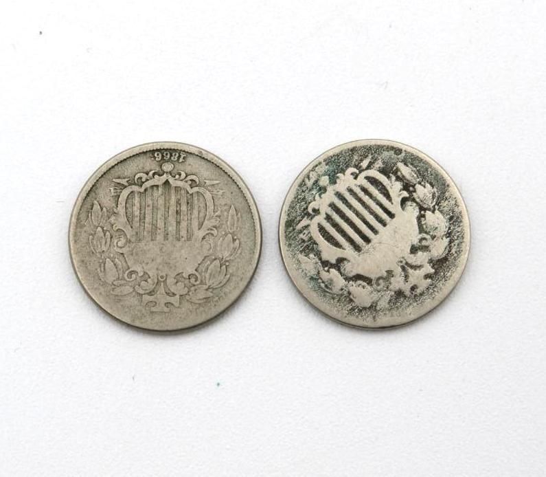 Two old silver U.S. Shield nickels with detailed designs of a shield, wreath, and crown on white background.
