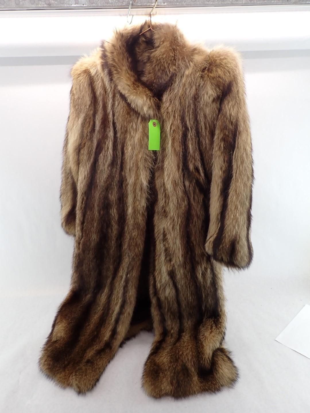 Long brown fur coat hanging with a green tag.