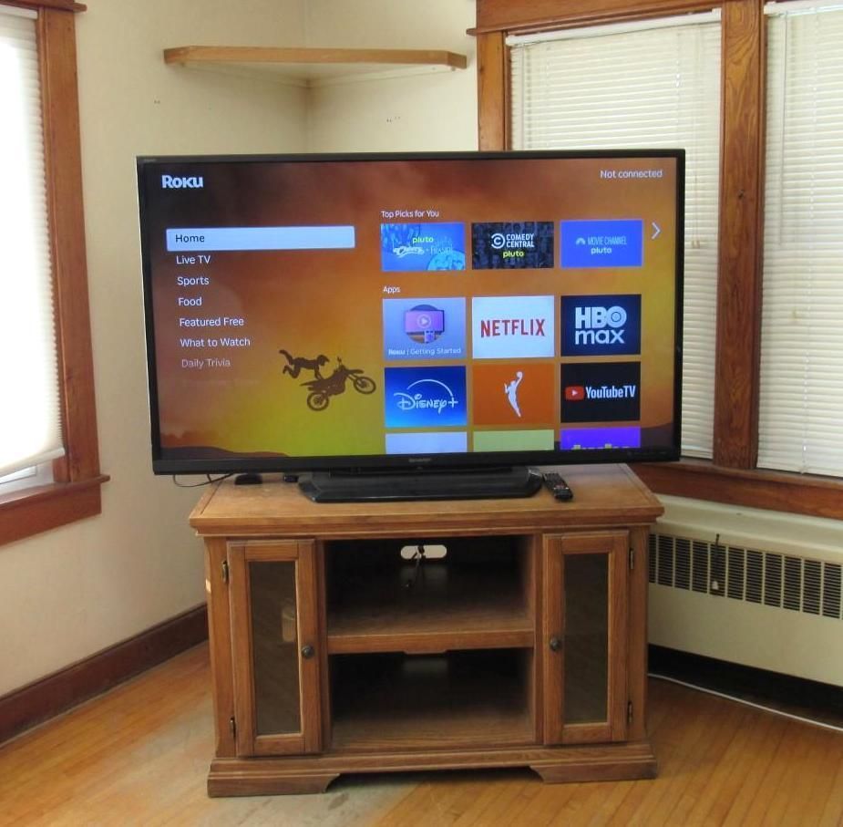 TV on a wooden cabinet.