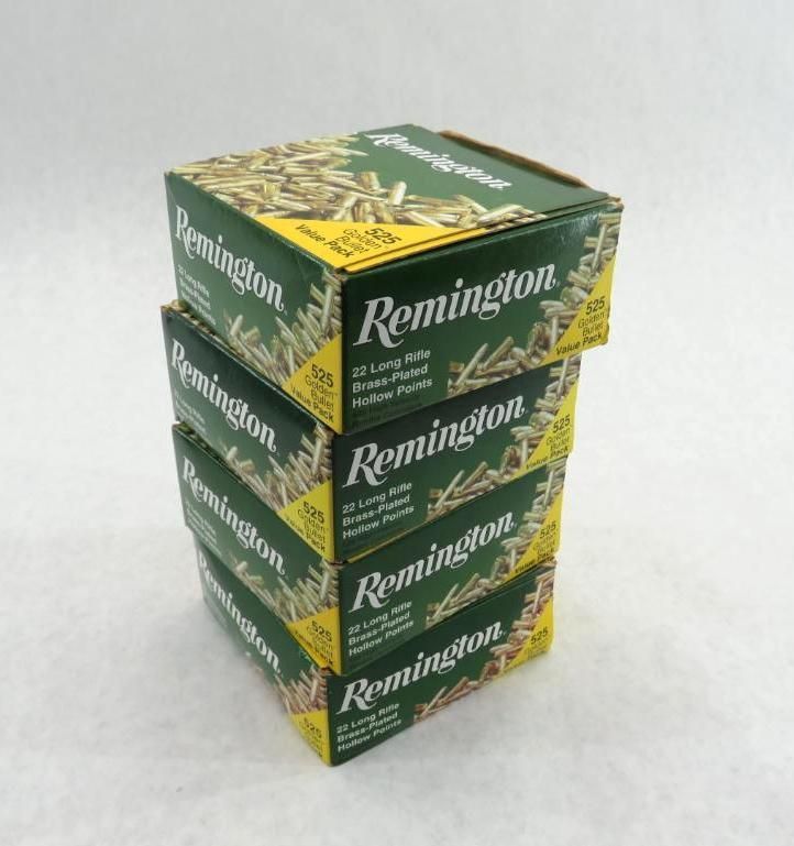 Stack of four green Remington 22 Long Rifle ammunition boxes.
