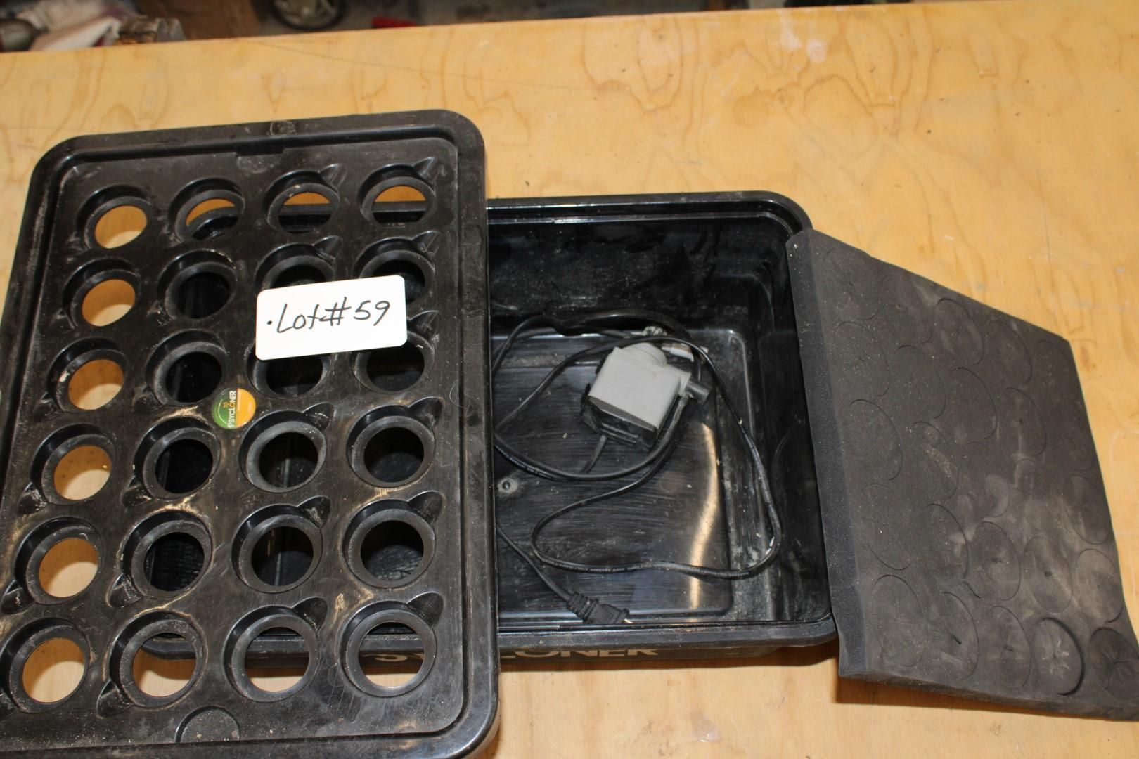 Black plastic hydroponic system with open lid, foam insert, and label.