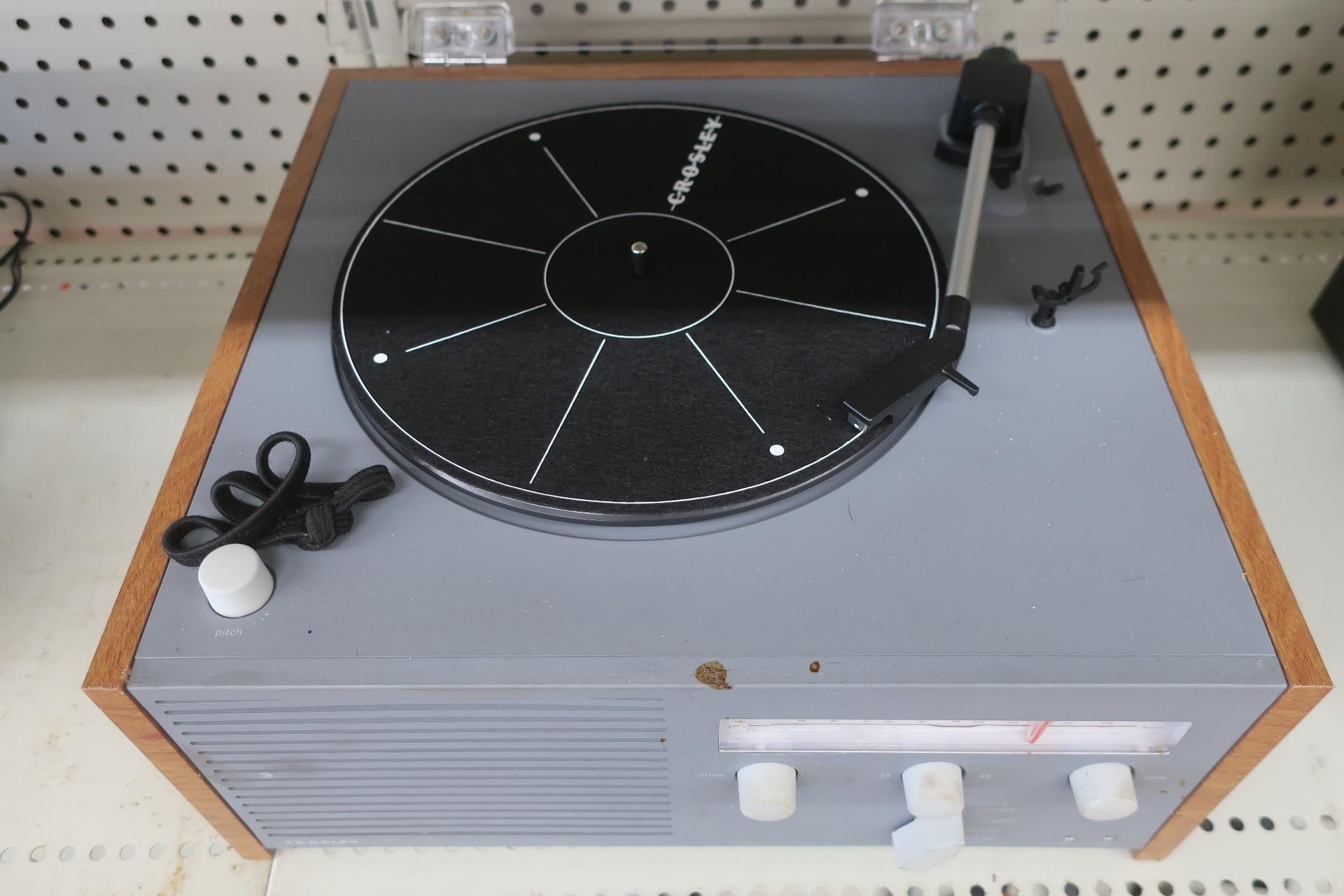 Vintage record player, gray and wood-toned, with a black record.