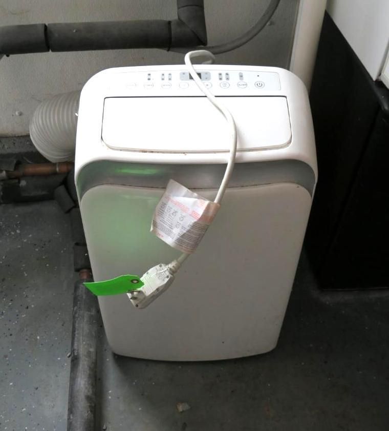 White portable air conditioner with a connected exhaust hose.