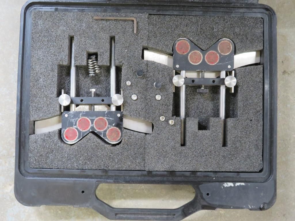 Two metal alignment tools in a black case with foam padding.