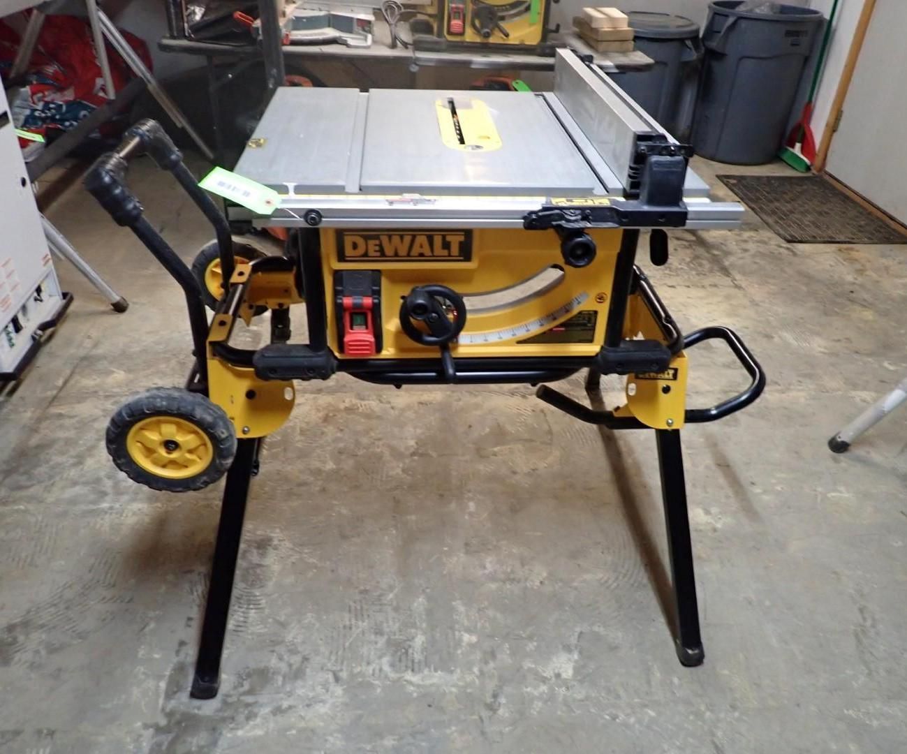 Yellow and black DeWalt table saw on a black stand, with wheels.