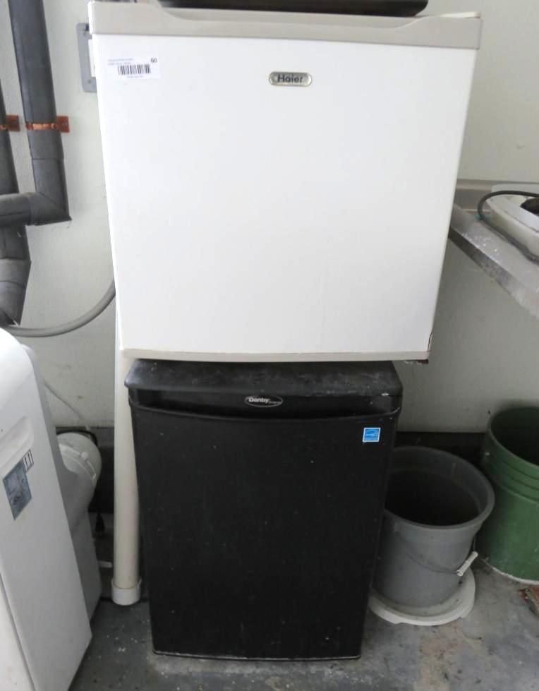 Two stacked refrigerators; white top, black bottom.