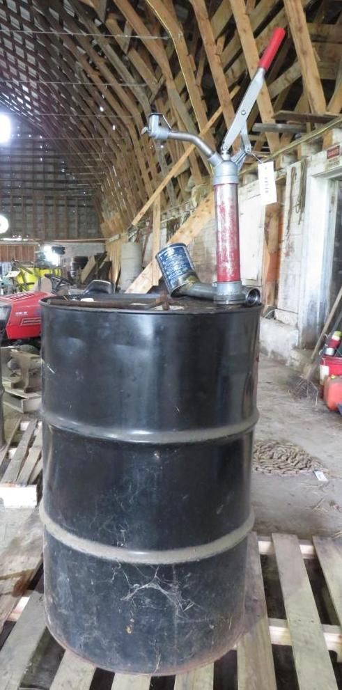 Black barrel with a hand pump.