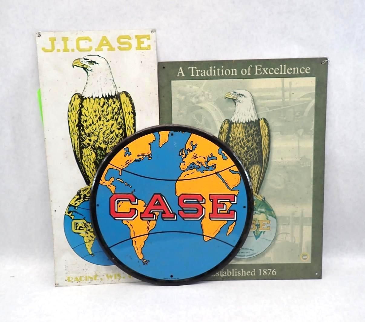 Three vintage J.I. Case signs with a bald eagle and globe design. The signs are cream and orange.