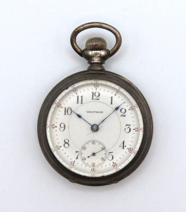 Antique silver pocket watch with a white face, black numbers, and a small seconds dial.