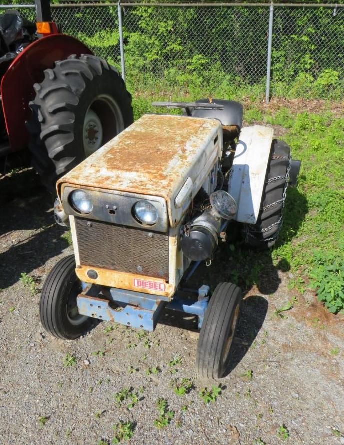 White and blue tractor in an outdoor setting.
